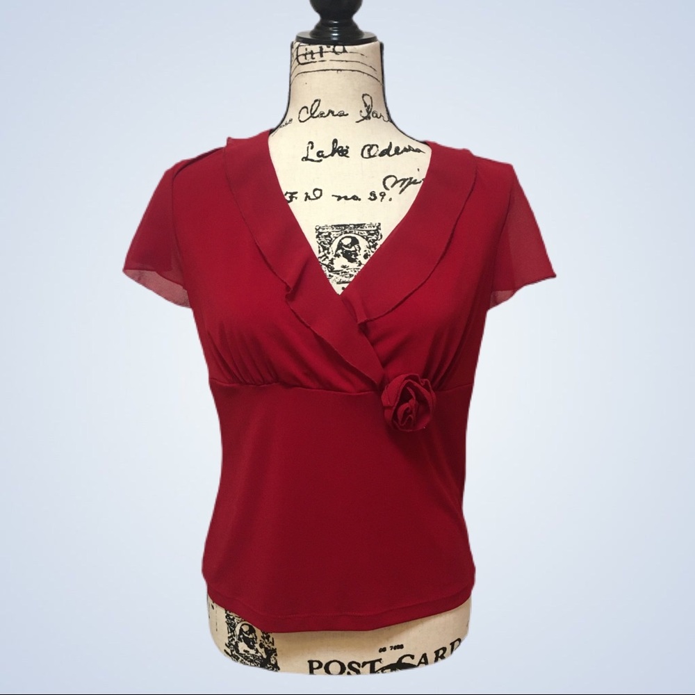 Darling red blouse with a flower accent